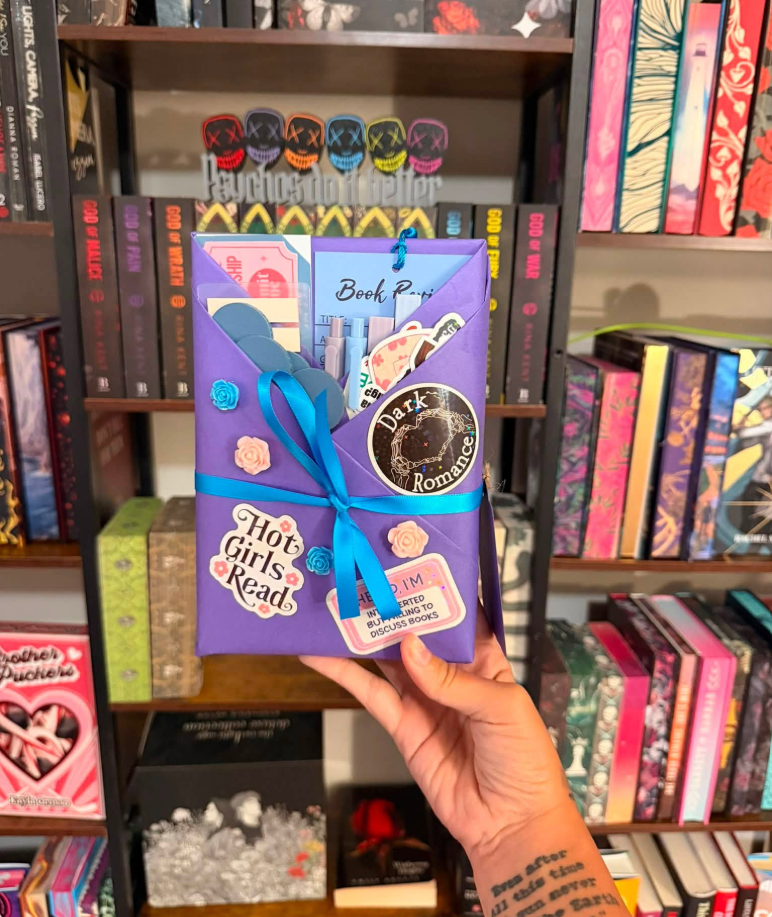 Purple-wrapped blind date book with Hot Girls Read and Dark Romance stickers