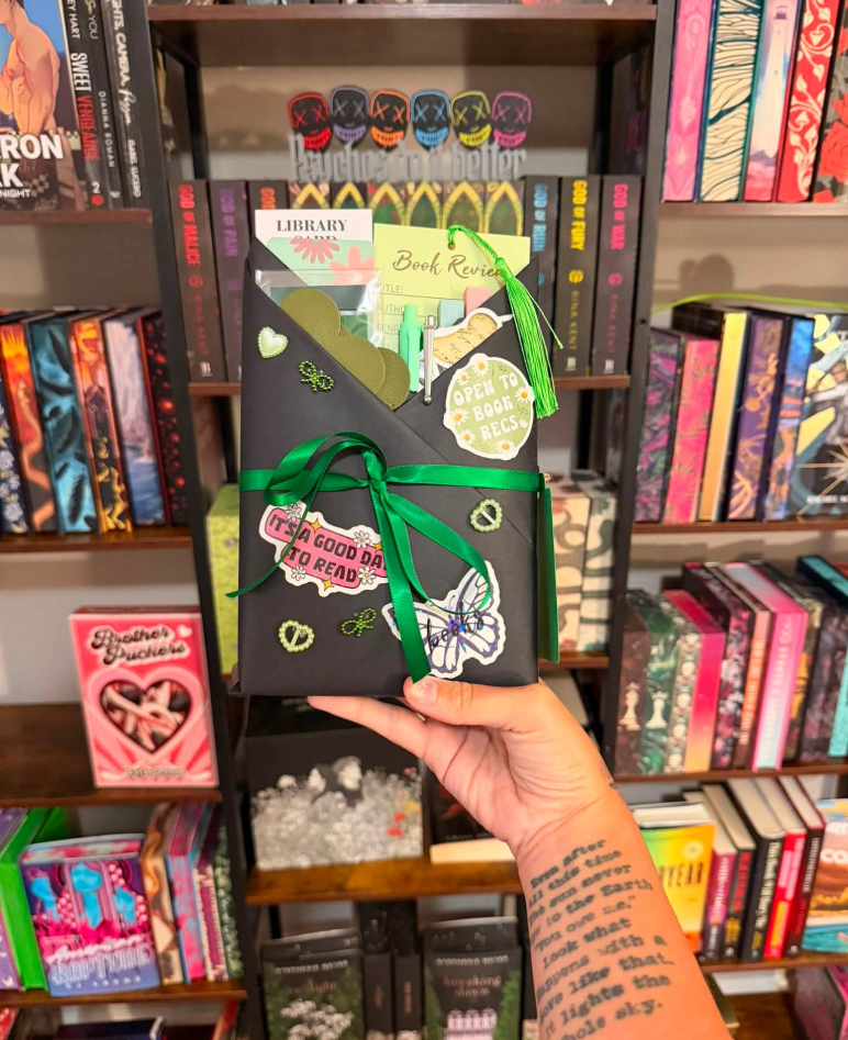 Black-wrapped blind date book with green ribbon and butterfly sticker