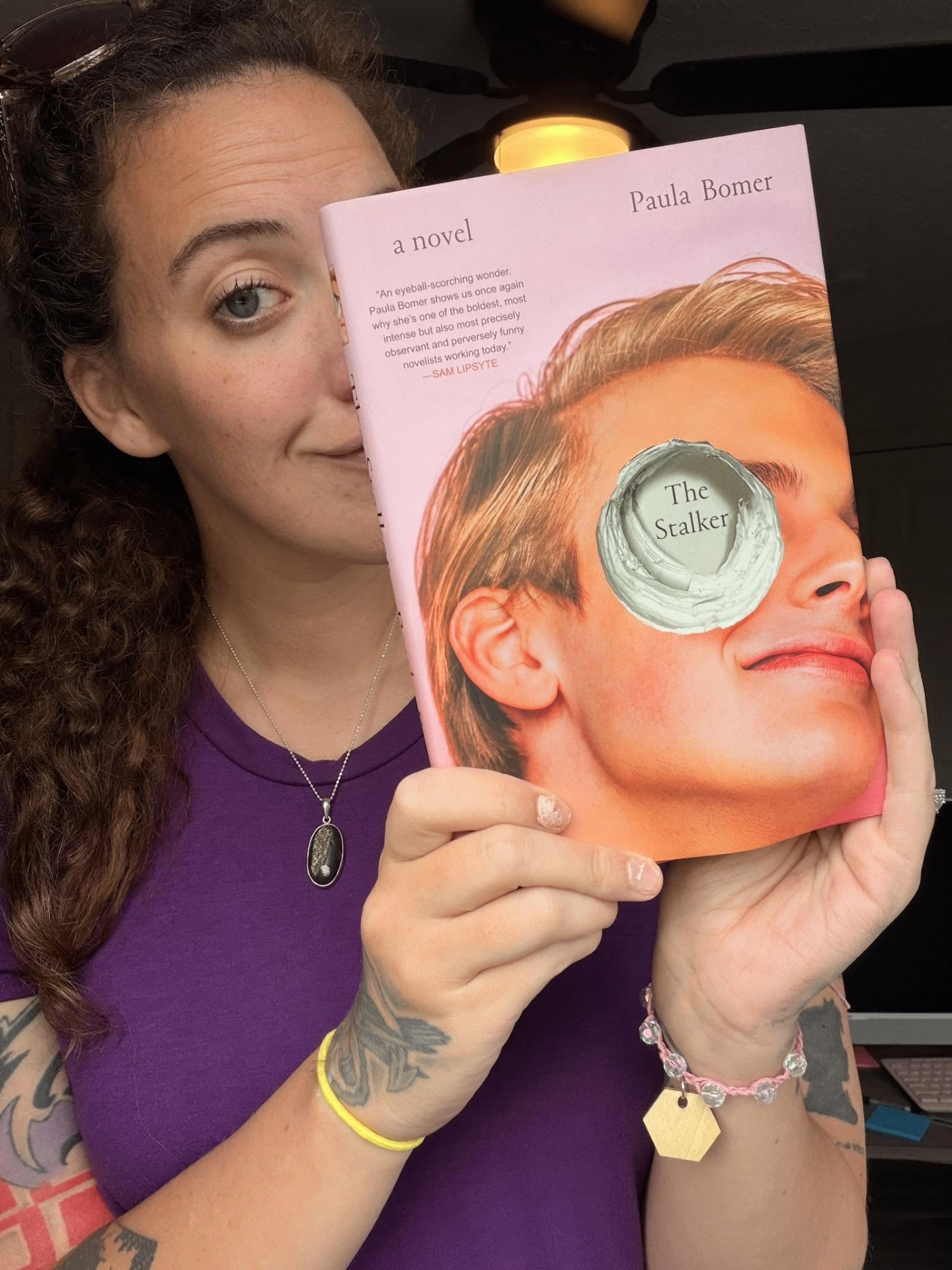 Emily holding a copy of The Stalker by Paula Bomer